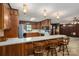 Kitchen featuring wood paneled walls, updated appliances, and an eat-in bar area with wooden stools at 5635 Highway 55 E Hwy, Clover, SC 29710