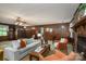 Cozy living room boasting wood paneling, a brick fireplace, and ample natural light at 5635 Highway 55 E Hwy, Clover, SC 29710