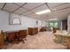 Open living room with natural light, wood desk, and furniture with patterned cushions at 5635 Highway 55 E Hwy, Clover, SC 29710