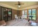 Enclosed patio featuring a ceiling fan, brick accents, barbecue, and an outdoor dining setup at 5635 Highway 55 E Hwy, Clover, SC 29710