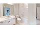 Bright bathroom with white vanity, toilet, bath-shower combination and neutral flooring at 608 Banter Ln # 31, Cramerton, NC 28032