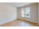 A bright room featuring hardwood floors, neutral walls, natural lighting, and windows at 608 Banter Ln # 31, Cramerton, NC 28032