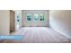 Spacious bedroom with three large windows and plush carpeting at 608 Banter Ln # 31, Cramerton, NC 28032