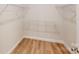 Bright walk-in closet with wood floor and wire shelving for storage at 608 Banter Ln # 31, Cramerton, NC 28032