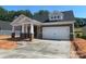 Charming one-story home featuring a covered porch and a two-car garage, complemented by stone and siding accents at 608 Banter Ln # 31, Cramerton, NC 28032