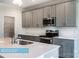 Close-up of a kitchen featuring gray cabinets and stainless steel appliances at 608 Banter Ln # 31, Cramerton, NC 28032