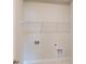 Functional laundry room with shelving and hookups ready for appliances at 608 Banter Ln # 31, Cramerton, NC 28032