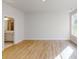 Open bedroom with a view into the bathroom and wood floors at 608 Banter Ln # 31, Cramerton, NC 28032