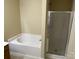 Bathroom features a white bathtub and a shower with glass doors, offering relaxation and convenience at 6130 Sid Crane Dr, Charlotte, NC 28216