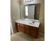 Bathroom with a single sink vanity, large mirror, and neutral finishes for a clean aesthetic at 6130 Sid Crane Dr, Charlotte, NC 28216