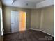Comfortable bedroom with neutral walls, plush carpeting, and a doorway that leads to another room at 6130 Sid Crane Dr, Charlotte, NC 28216