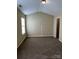 Spacious bedroom with a high ceiling, neutral walls, and plush carpeting at 6130 Sid Crane Dr, Charlotte, NC 28216