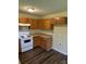 Functional kitchen with wooden cabinetry, laminate countertops, and standard appliances at 6130 Sid Crane Dr, Charlotte, NC 28216
