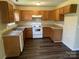 Well-lit kitchen with wooden cabinets, laminate countertops, and modern appliances at 6130 Sid Crane Dr, Charlotte, NC 28216