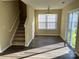 Open-concept living area with staircase, modern lighting fixture, and sliding glass doors at 6130 Sid Crane Dr, Charlotte, NC 28216