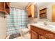 Functional bathroom with a vanity sink, tiled floors, and ample storage space at 614 W Peeler St, Salisbury, NC 28146
