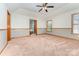 Large bedroom features neutral walls, carpet, natural light, and view into Primary bathroom at 614 W Peeler St, Salisbury, NC 28146