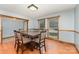 Dining room with wood floors, a large table, and two windows, offering a comfortable space for meals at 614 W Peeler St, Salisbury, NC 28146