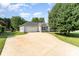Inviting exterior showcasing a well-maintained lawn, a mature tree, and a long driveway leading to an attached garage at 614 W Peeler St, Salisbury, NC 28146