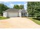 Well-kept exterior featuring a spacious driveway, a lush lawn, and tidy landscaping, adding to its curb appeal at 614 W Peeler St, Salisbury, NC 28146