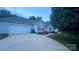 Charming home with a well-manicured lawn and a long driveway leading to an attached two-car garage at 614 W Peeler St, Salisbury, NC 28146