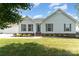 Charming single story home featuring manicured lawn, landscaped garden beds, and stylish shutters at 614 W Peeler St, Salisbury, NC 28146