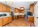 Bright kitchen includes wood cabinets, laminate countertops, wood-look flooring, and modern appliances at 614 W Peeler St, Salisbury, NC 28146