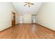 Open living room with wood-look floors, a ceiling fan, and neutral walls, offering a versatile living space at 614 W Peeler St, Salisbury, NC 28146