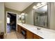 Bathroom featuring a long vanity with dual mirrors and sinks, along with an adjacent bedroom at 6811 Ledgestone Pl, Charlotte, NC 28227