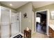 Bright bathroom featuring a walk-in shower with glass door and a doorway to the bedroom at 6811 Ledgestone Pl, Charlotte, NC 28227