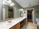 Bathroom with double sink vanity, shower and closet storage space at 6811 Ledgestone Pl, Charlotte, NC 28227