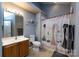 Well-lit bathroom featuring a vanity, toilet, and shower with a decorative curtain at 6811 Ledgestone Pl, Charlotte, NC 28227