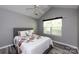 Cozy bedroom with vaulted ceiling, ceiling fan, gray walls, and a window providing natural light at 6811 Ledgestone Pl, Charlotte, NC 28227