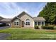 Charming home exterior with stone accents, manicured shrubs, and a lush green lawn on a sunny day at 6811 Ledgestone Pl, Charlotte, NC 28227