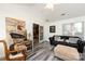 Inviting living room featuring gray plank floors, neutral colors, and bright natural light at 6811 Ledgestone Pl, Charlotte, NC 28227