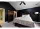Black and gold main bedroom showcasing statement walls, hardwood floors, and decorative furniture at 6811 Ledgestone Pl, Charlotte, NC 28227