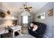 Stylish office space with vaulted ceiling, modern decor, gray plank floors, and plenty of natural light at 6811 Ledgestone Pl, Charlotte, NC 28227