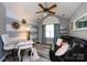 Stylish office space with vaulted ceiling, modern decor, gray plank floors, and plenty of natural light at 6811 Ledgestone Pl, Charlotte, NC 28227