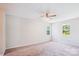 Bright, airy bedroom showcasing two windows and neutral carpeting at 7217 Rena Mae Ln, Charlotte, NC 28227