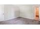 This bedroom offers neutral carpeting and a doorway to the bathroom at 7217 Rena Mae Ln, Charlotte, NC 28227