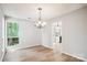 Dining room features hardwood floors, a modern chandelier, and natural light at 7217 Rena Mae Ln, Charlotte, NC 28227