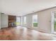 Bright living room with a brick fireplace and hardwood floors at 7217 Rena Mae Ln, Charlotte, NC 28227