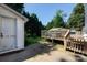 Backyard deck with stairs and railings, connecting to a shed in a grassy yard at 801 Fugate Ave, Charlotte, NC 28205