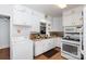 White kitchen with light colored counters, appliances, and laminate floors at 801 Fugate Ave, Charlotte, NC 28205