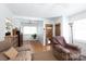 Cozy living room with hardwood floors, front door, and front windows at 801 Fugate Ave, Charlotte, NC 28205