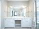 Bright bathroom features a double vanity and a shower with a glass door at 8409 Darcy Hopkins Dr, Charlotte, NC 28277