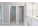 Bright bathroom leads to walk-in closets with wire shelving at 8409 Darcy Hopkins Dr, Charlotte, NC 28277