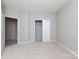Bright, empty bedroom has neutral walls and a walk-in closet at 8409 Darcy Hopkins Dr, Charlotte, NC 28277