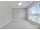 Bedroom featuring neutral carpet, ceiling fan, and a large window offering ample natural light at 8409 Darcy Hopkins Dr, Charlotte, NC 28277