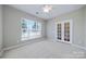 Bright bedroom features a ceiling fan and large windows providing natural light at 8409 Darcy Hopkins Dr, Charlotte, NC 28277